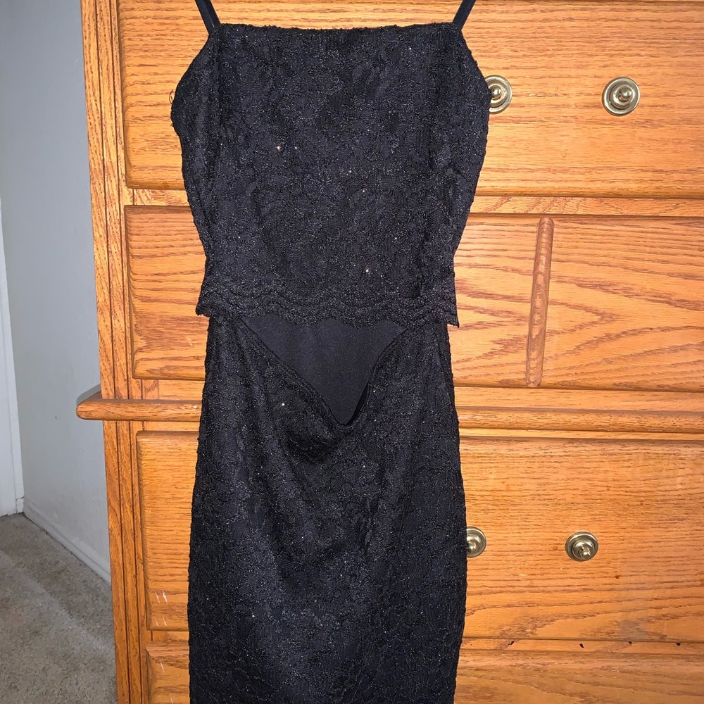 A black above the knee dress with a cut in the stomach area, size small